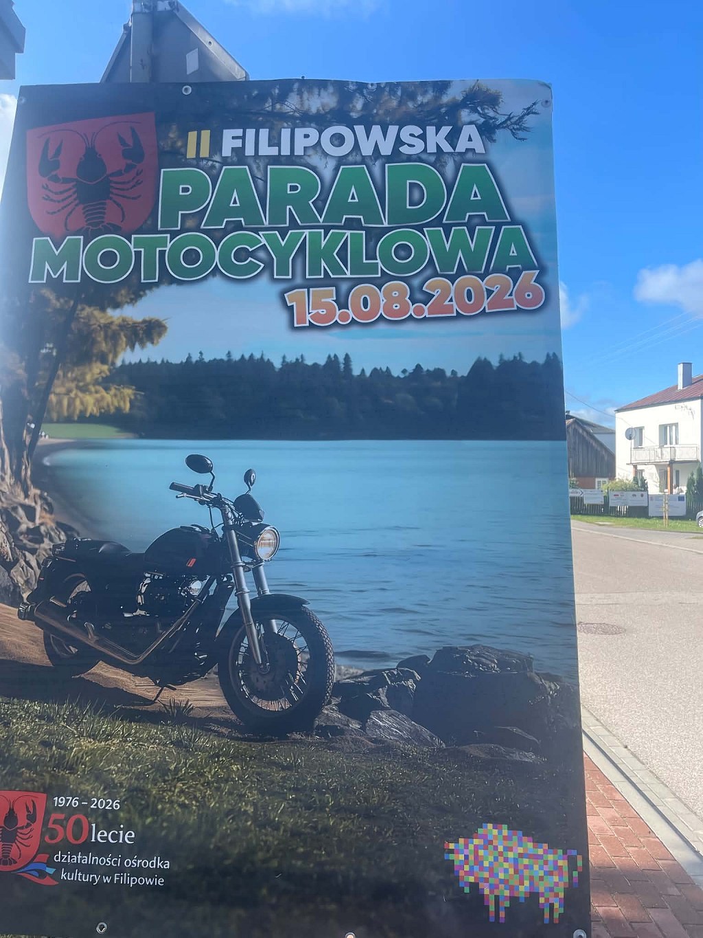 II Filipowska Parada Motocyklowa, 15.08.2026. Plakat z motocyklem zaparkowanym nad jeziorem